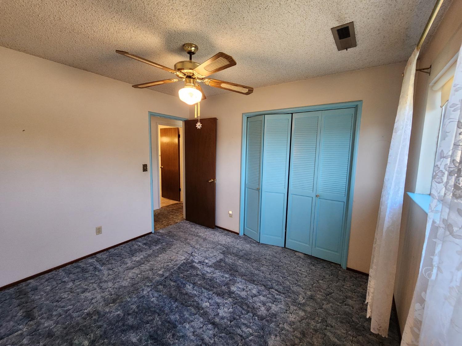 3653 Wright Street Selma, CA 93662 - Photo 30 of 41 an empty room with closet and a chandelier fan