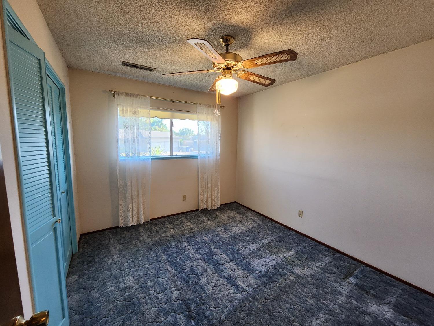 3653 Wright Street Selma, CA 93662 - Photo 31 of 41 an empty room with windows and fan