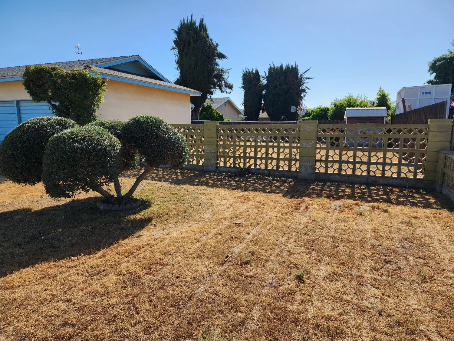3653 Wright Street Selma, CA 93662 - Photo 10 of 41 a view of a street with a wooden fence