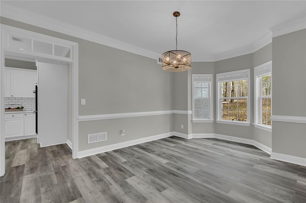 857 Cooper Road Social Circle, GA 30025 - Photo 15 of 88 a view of empty room with wooden floor and window