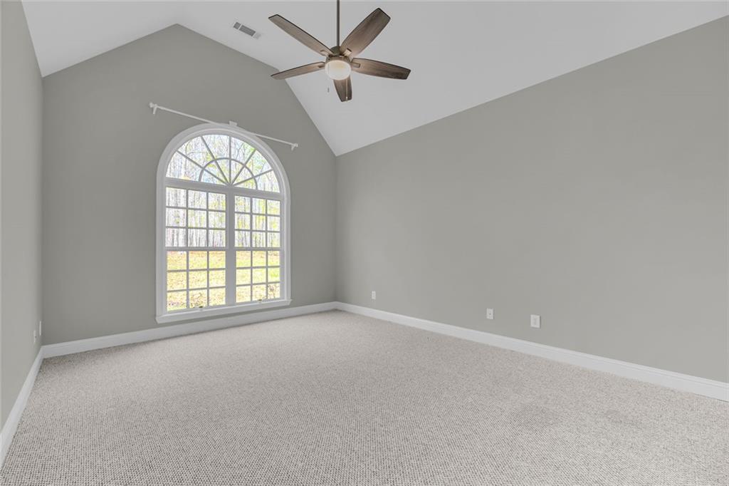 857 Cooper Road Social Circle, GA 30025 - Photo 20 of 88 an empty room with windows and ceiling fan