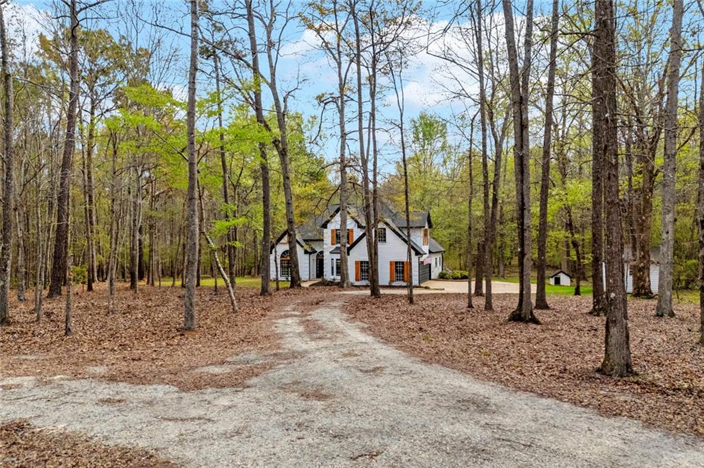 857 Cooper Road Social Circle, GA 30025 - Photo 2 of 88 a view of a house with a trees in the background