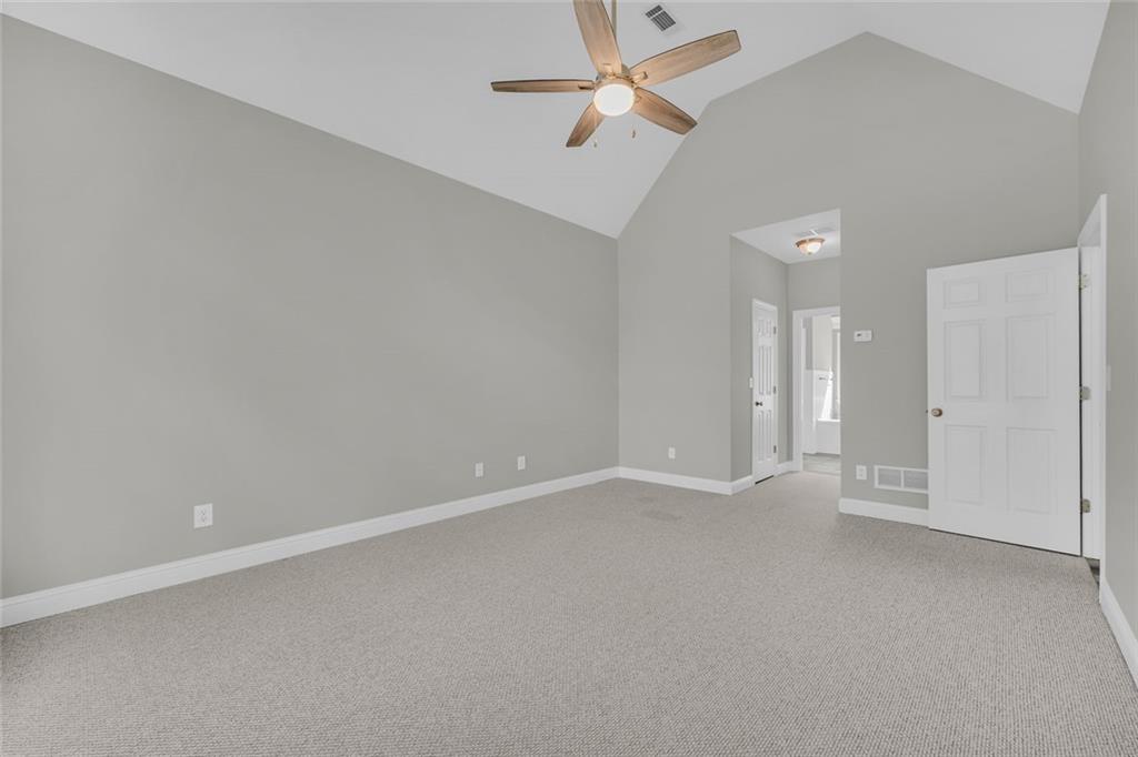 857 Cooper Road Social Circle, GA 30025 - Photo 21 of 88 an empty room with a ceiling fan and closet