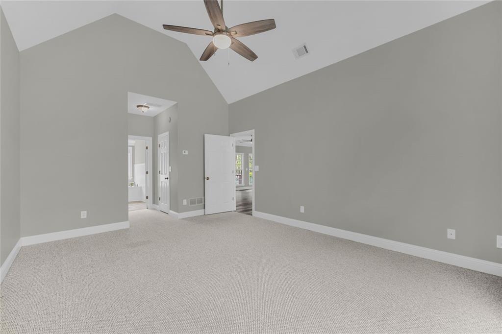 857 Cooper Road Social Circle, GA 30025 - Photo 22 of 88 an empty room with a ceiling fan and a window