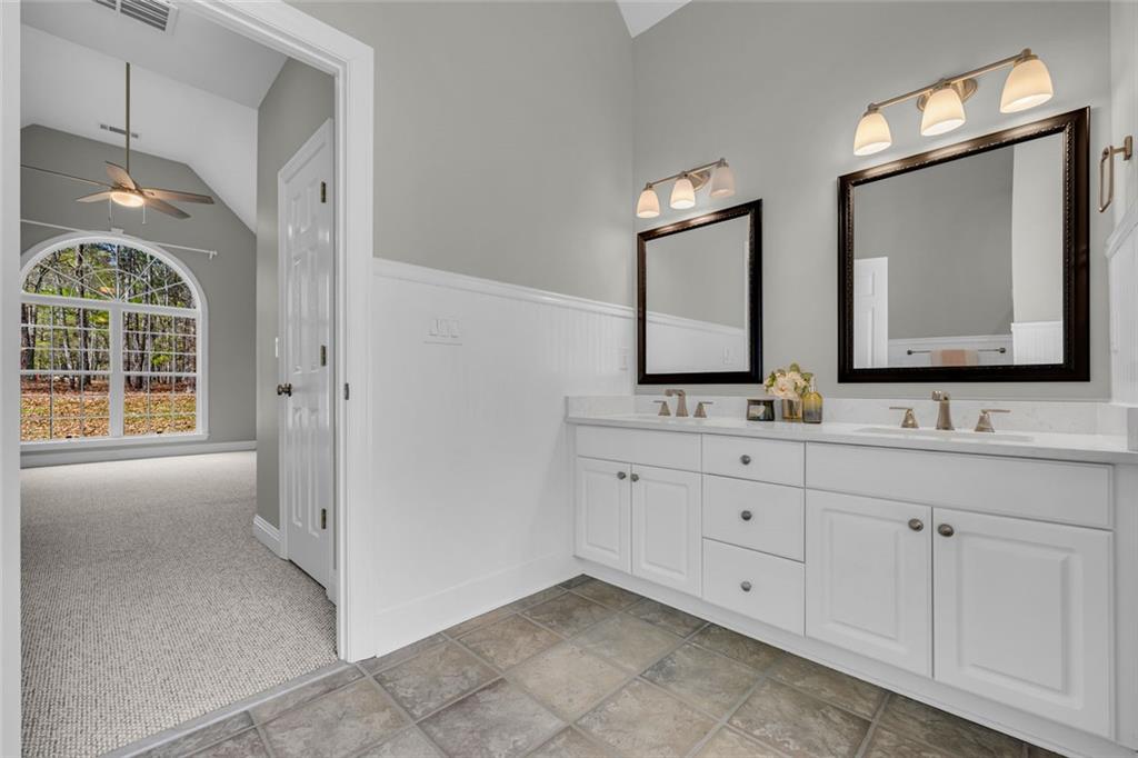 857 Cooper Road Social Circle, GA 30025 - Photo 25 of 88 a bathroom with a double vanity sink mirror and