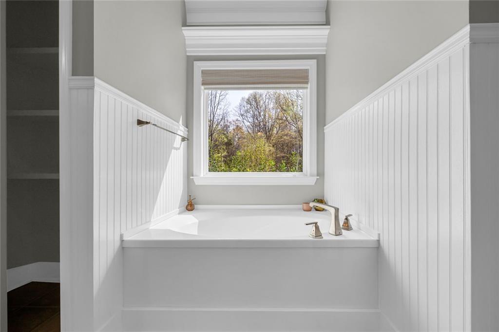 857 Cooper Road Social Circle, GA 30025 - Photo 26 of 88 a bathroom with a bathtub and window