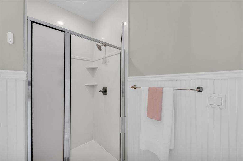 857 Cooper Road Social Circle, GA 30025 - Photo 27 of 88 a bathroom with a shower and a glass door