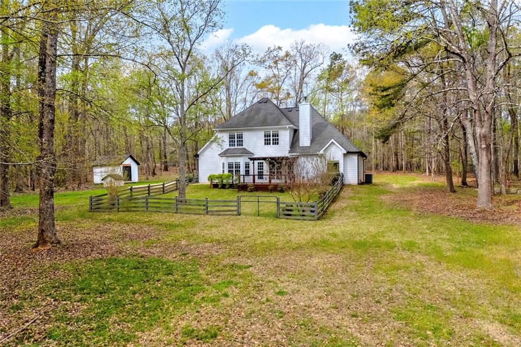 857 Cooper Road Social Circle, GA 30025 - Photo 3 of 88 a view of a house with a big yard
