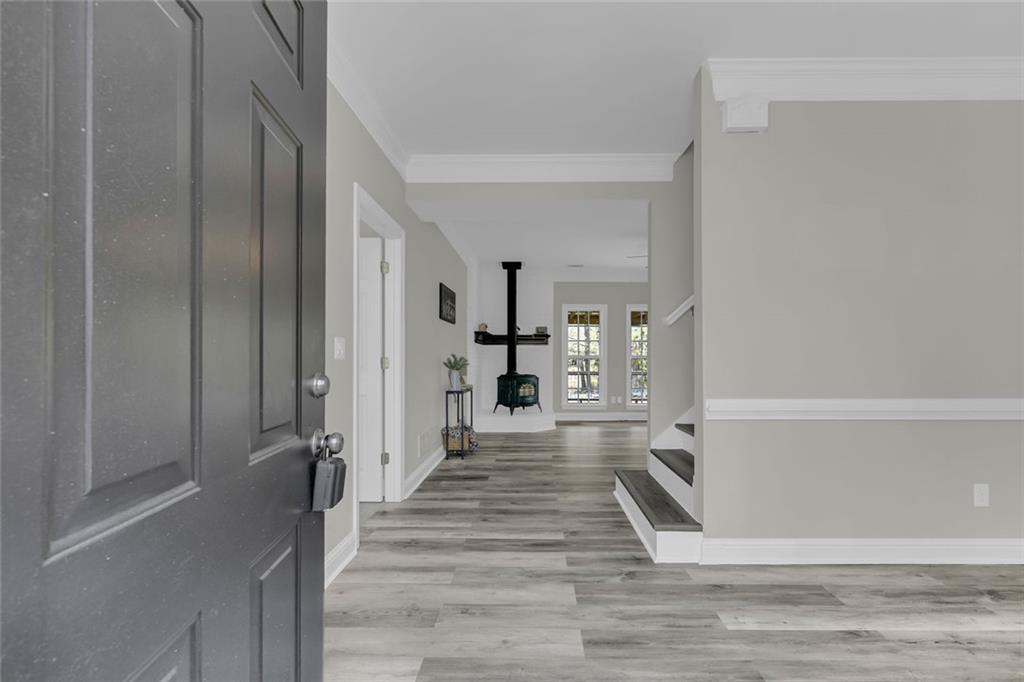 857 Cooper Road Social Circle, GA 30025 - Photo 4 of 88 a view of a hallway with wooden floor and staircase