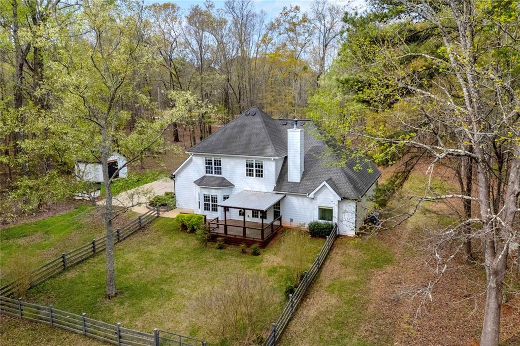 857 Cooper Road Social Circle, GA 30025 - Photo 50 of 88 a front view of a house with a yard table and chairs