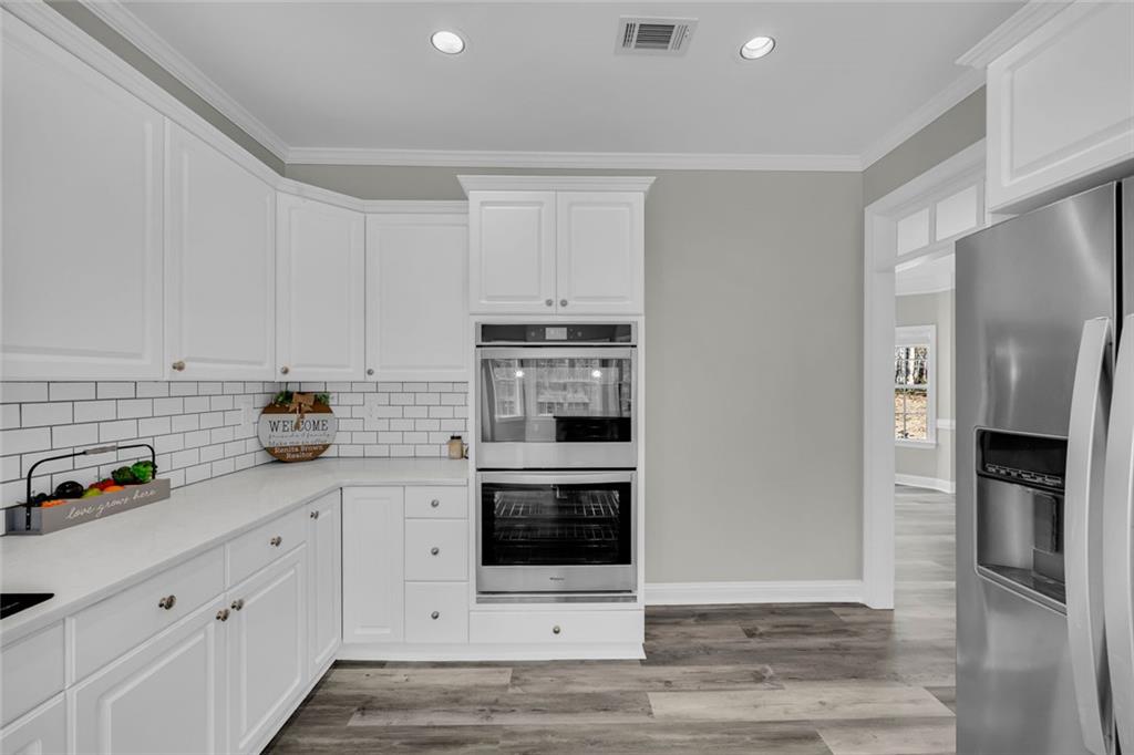 857 Cooper Road Social Circle, GA 30025 - Photo 10 of 88 a kitchen with stainless steel appliances a stove a refrigerator and a sink