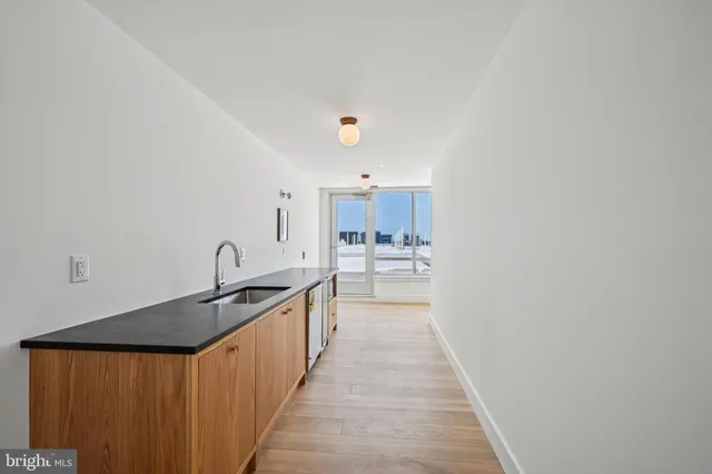 a kitchen with stainless steel appliances granite countertop a sink and cabinets