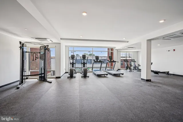 a view of a room with gym equipment and a large window