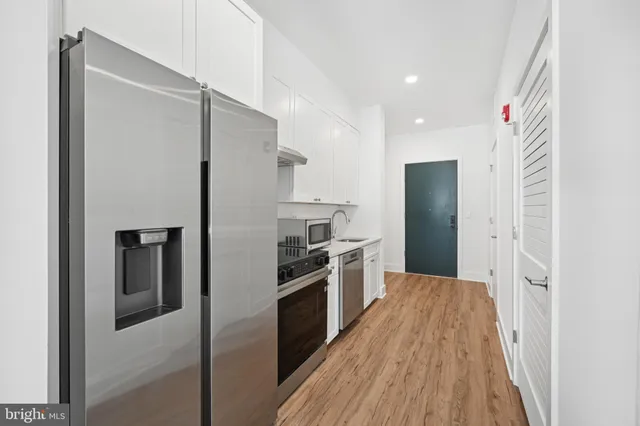 a kitchen with a refrigerator a sink and dishwasher