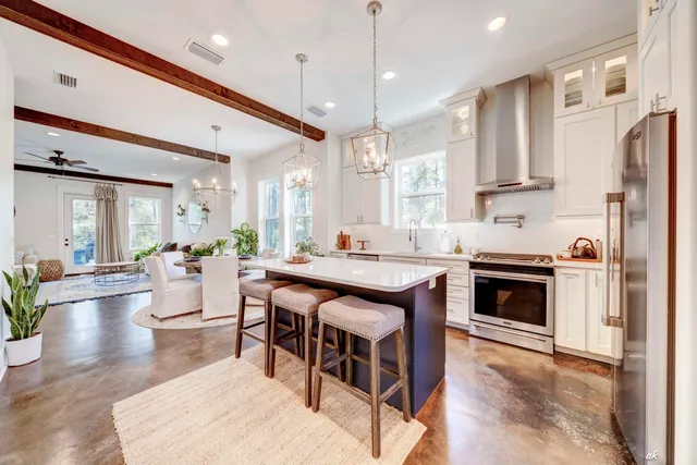 a large kitchen with a table and chairs