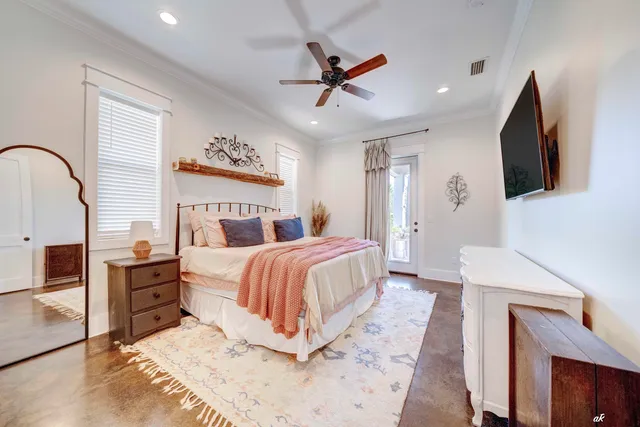 a bedroom with a large bed and a flat screen tv