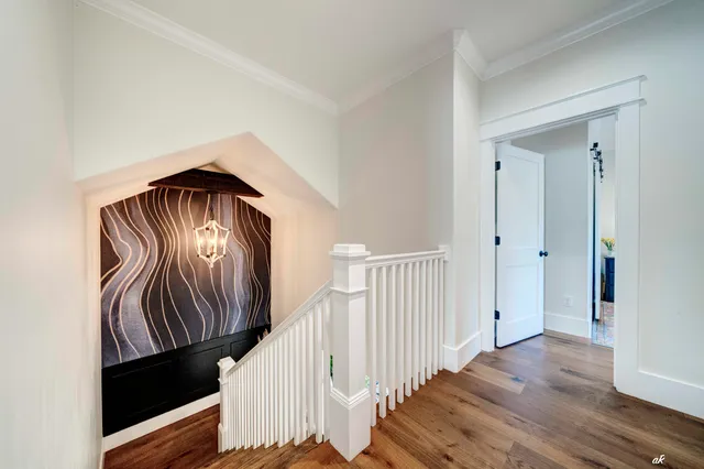 a view of entryway and hall with wooden floor