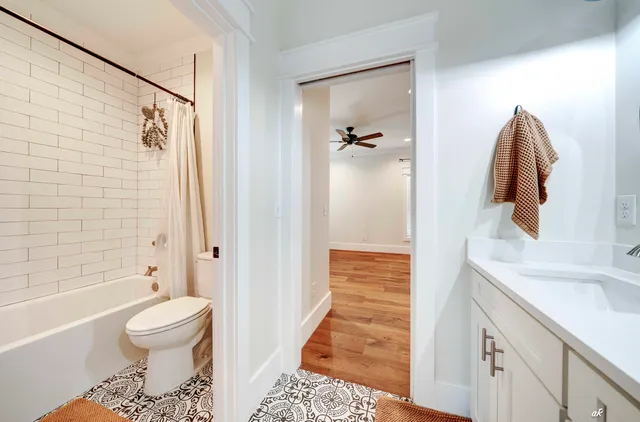 a bathroom with a sink toilet and shower