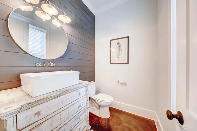 a bathroom with a toilet a sink and mirror