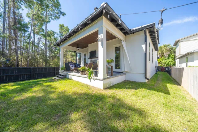 a view of a house with a yard and porch