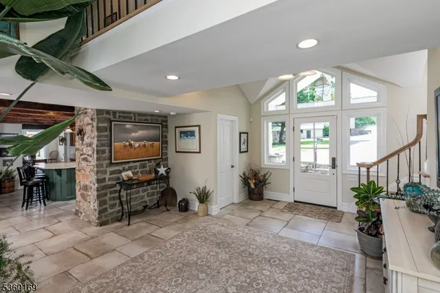 a living room with furniture a flat screen tv and potted plants