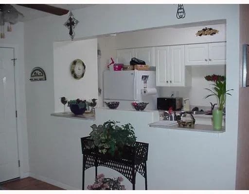 a kitchen with a refrigerator and a stove