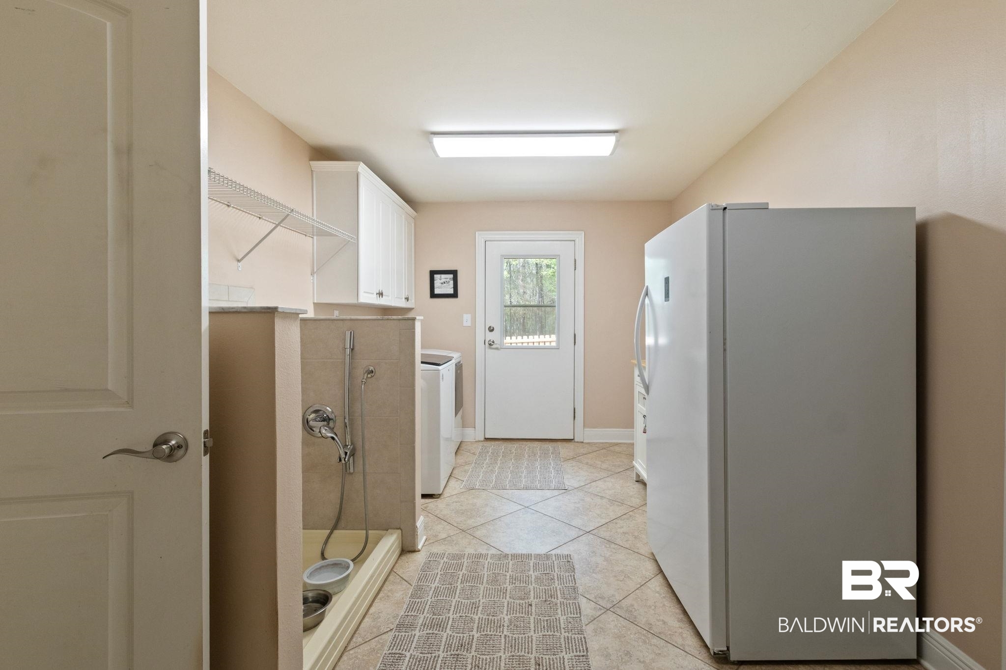 24250 Hack Road Bay Minette, AL 36507 - Photo 42 of 88 Laundry room featuring light tile patterned floors, cabinet space, and separate washer and dryer