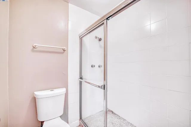 a bathroom with a toilet and a shower