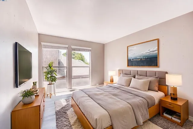 a bedroom with a large bed and a flat screen tv