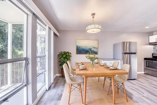 a view of a dining room with furniture window and wooden floor