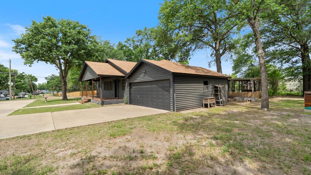 129 King Arthur Road Mabank, TX 75156 - Photo 5 of 33 The property features a concrete driveway, a front porch, and an attached garage