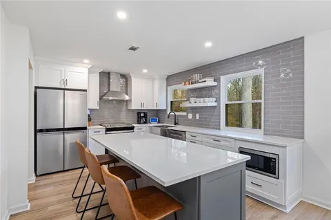 a kitchen with a stove a refrigerator and a table