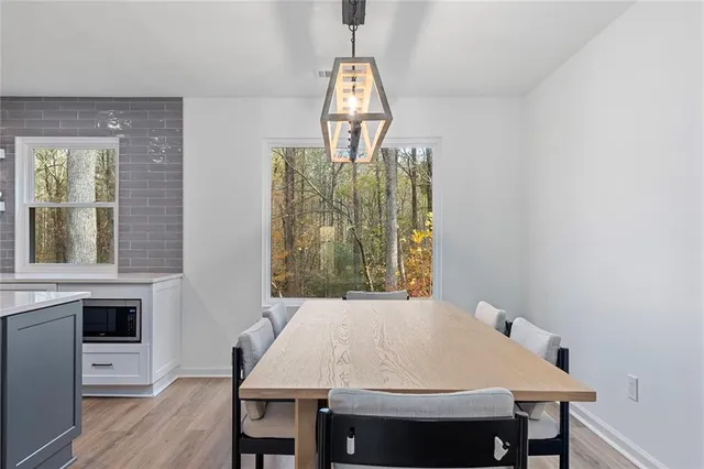 a view of a dining room with furniture window and wooden floor