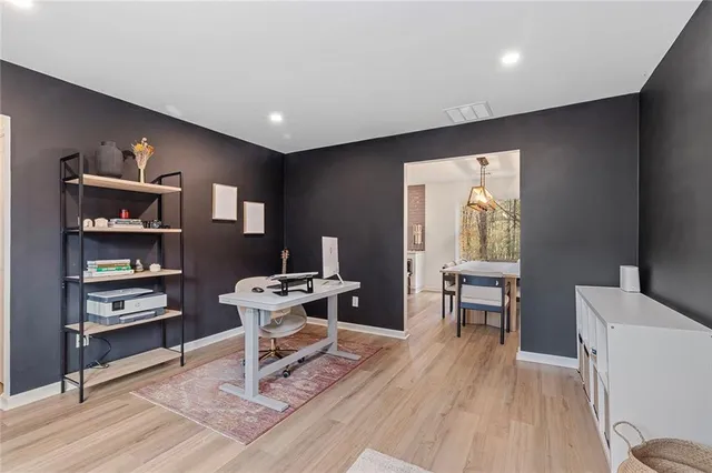 a work room with furniture and a wooden floor