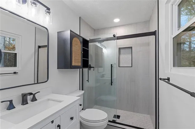 a bathroom with a shower and a mirror