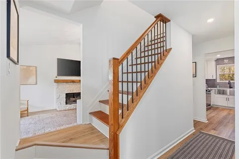 a view of entryway and hall with wooden floor