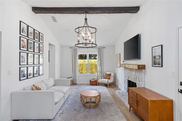 a living room with furniture a fireplace and a flat screen tv