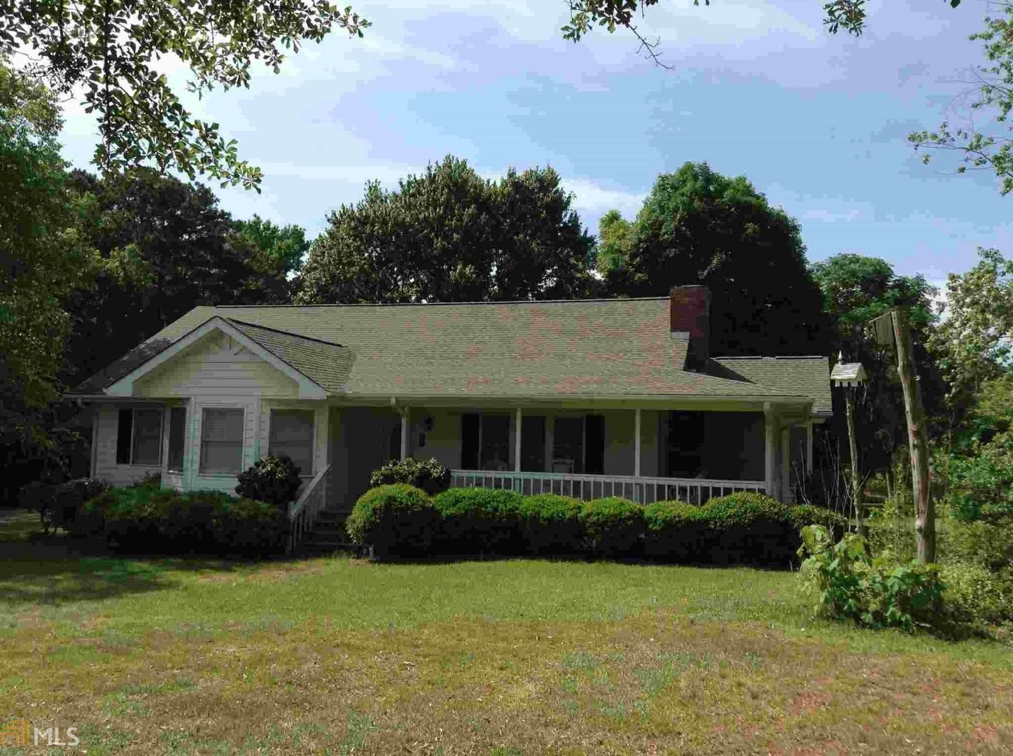 525 Conkle Road Hampton, GA 30228 - Photo 1 of 1 a front view of a house with a garden