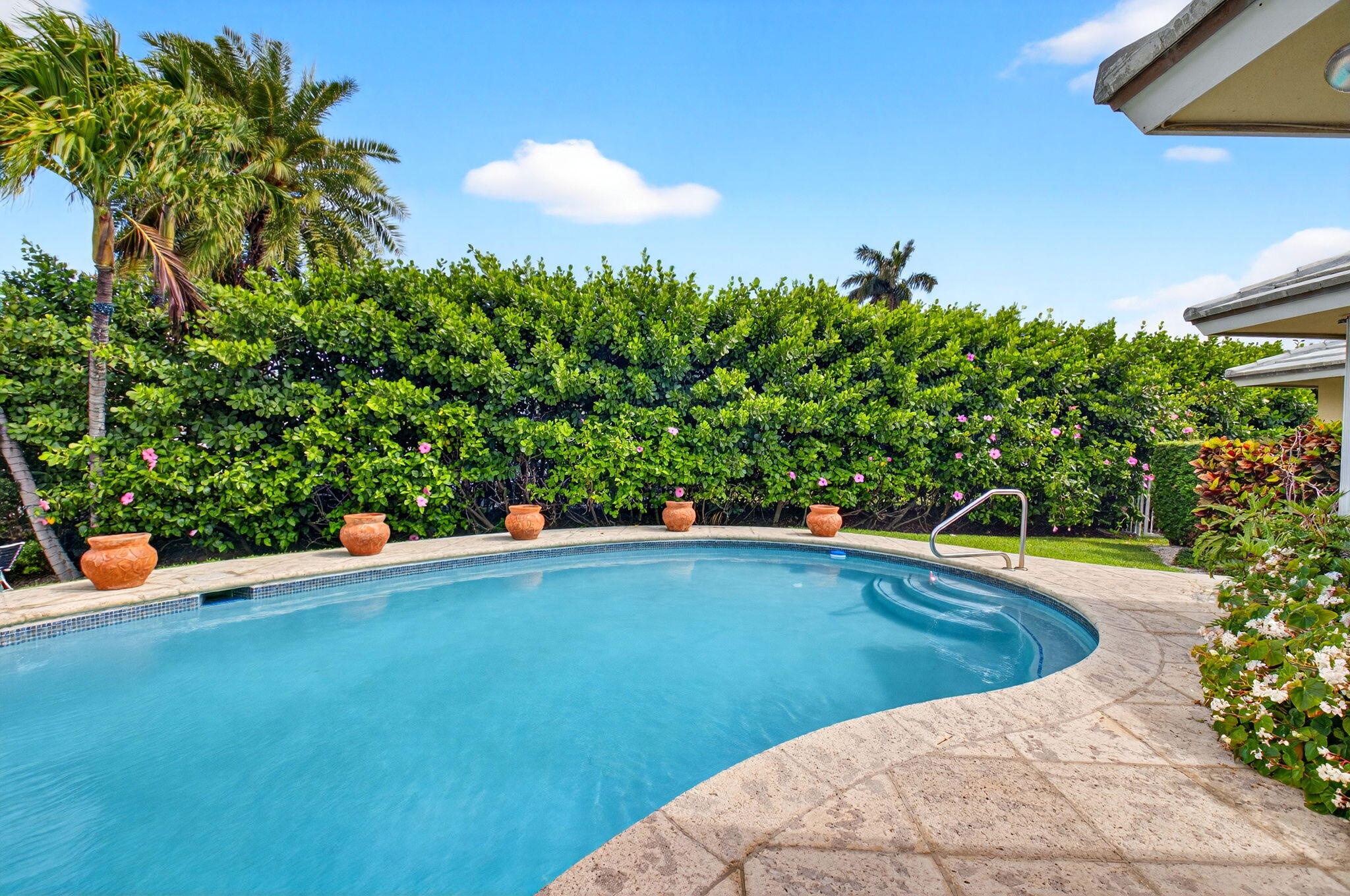 30 Spanish River Drive Ocean Ridge, FL 33435 - Photo 51 of 68 a view of a swimming pool with an outdoor space and seating area