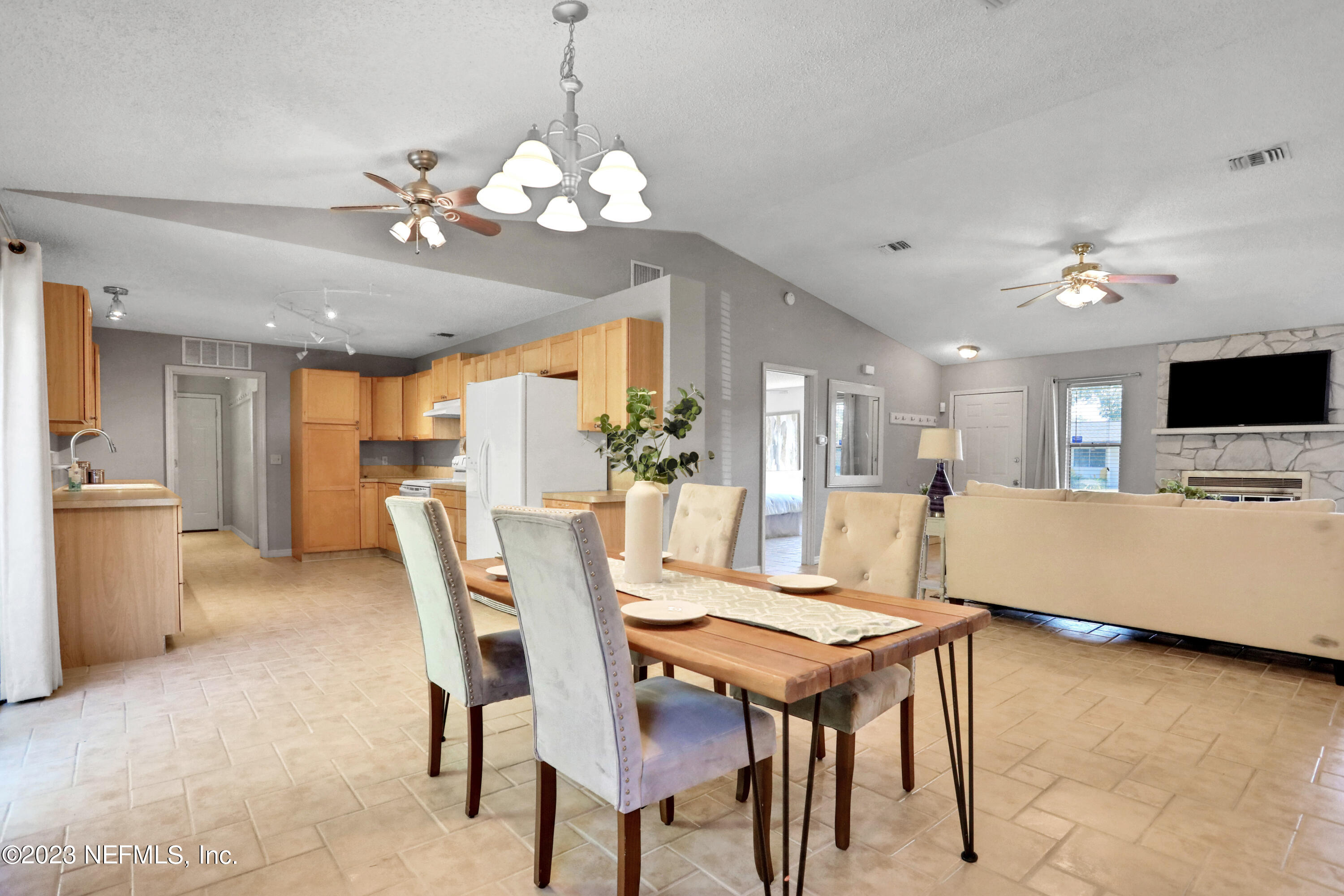 3826 Eunice Road Jacksonville, FL 32250 - Photo 23 of 45 a view of a dining room with furniture and chandelier