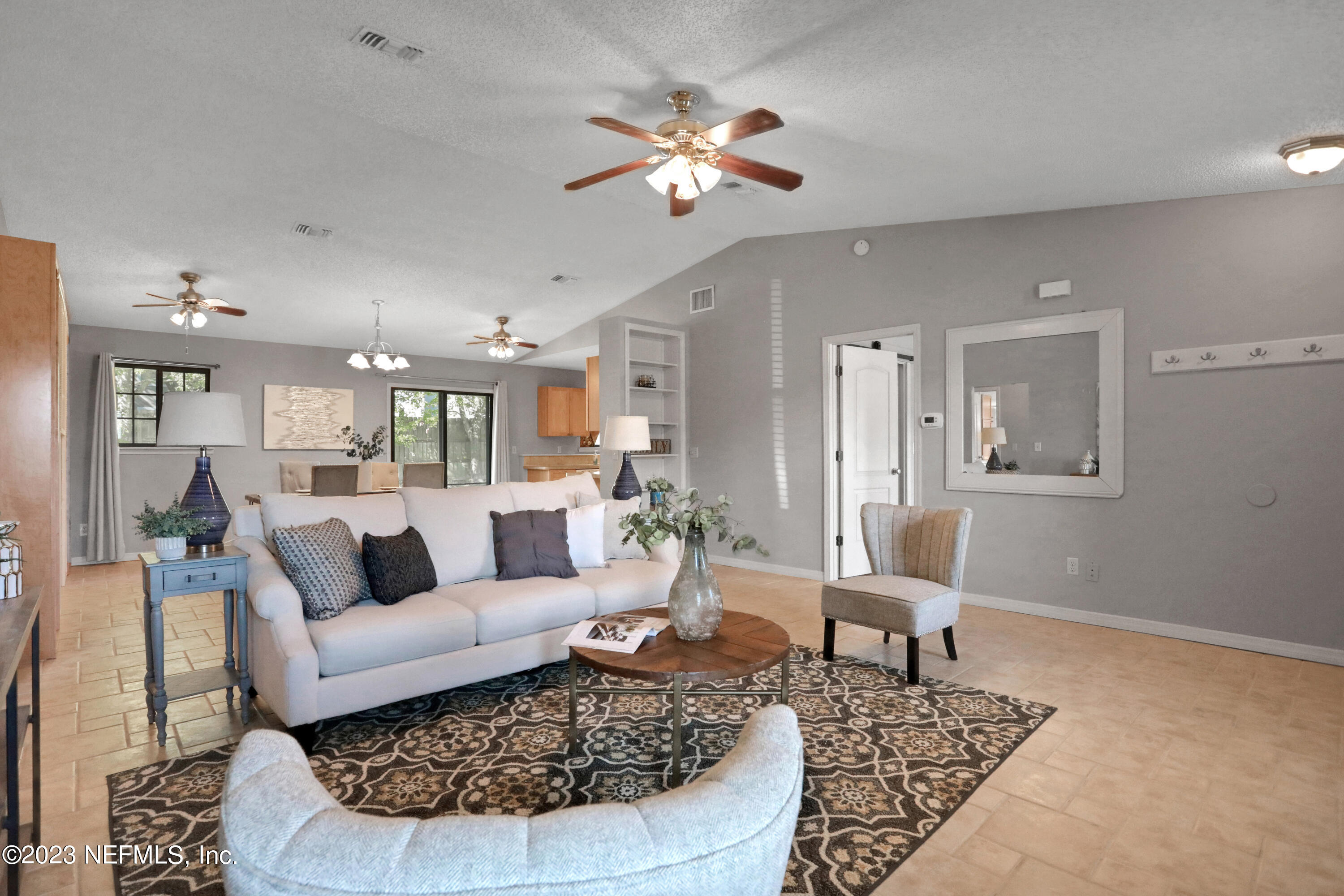 3826 Eunice Road Jacksonville, FL 32250 - Photo 28 of 45 a living room with furniture and a chandelier