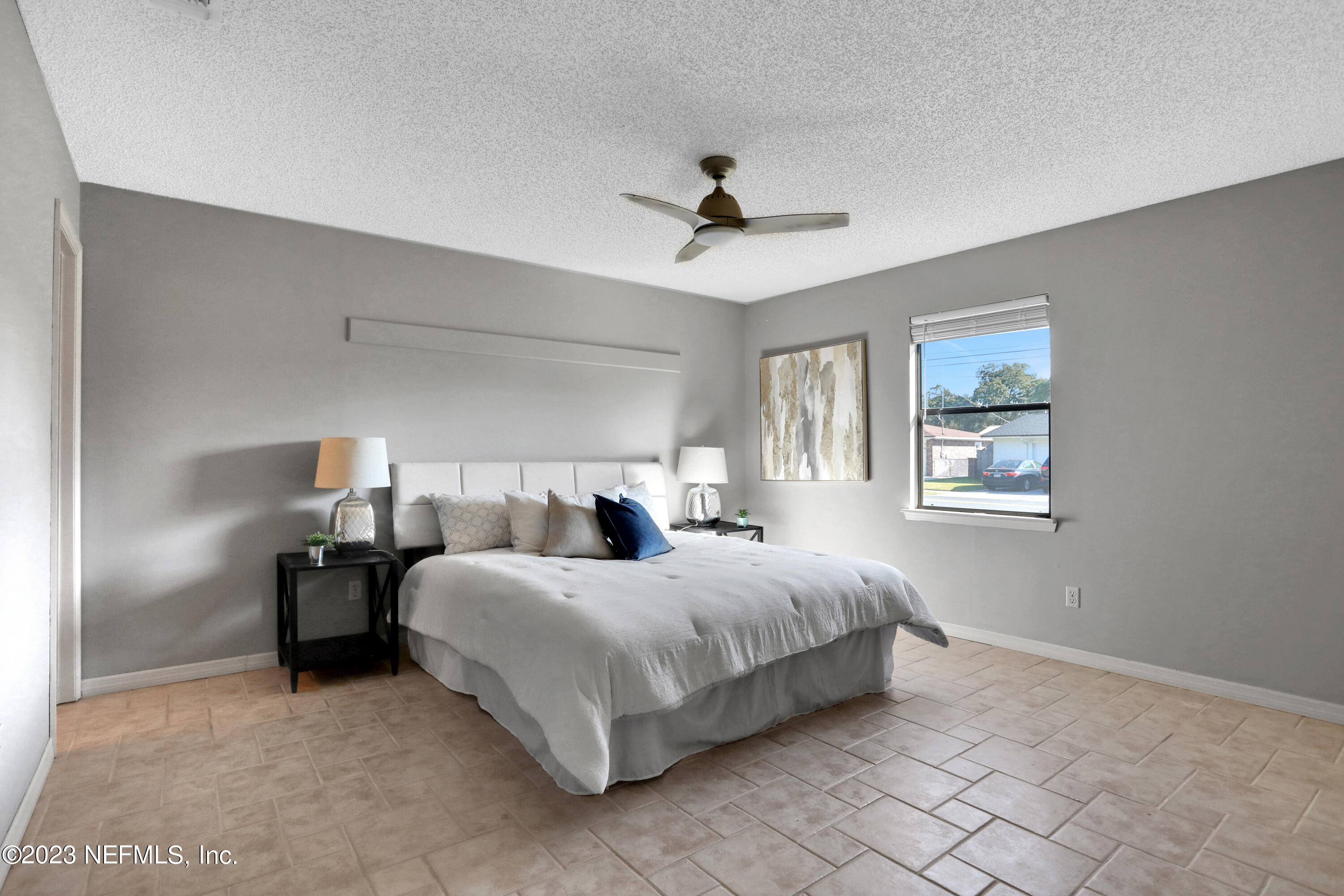 3826 Eunice Road Jacksonville, FL 32250 - Photo 4 of 45 a bedroom with a bed and a chandelier