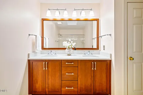 a bathroom with a sink vanity and a mirror