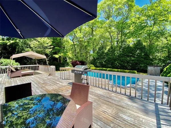 a view of a patio with couches under an umbrella