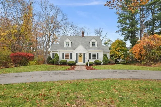 a view of a house with a yard and potted plants