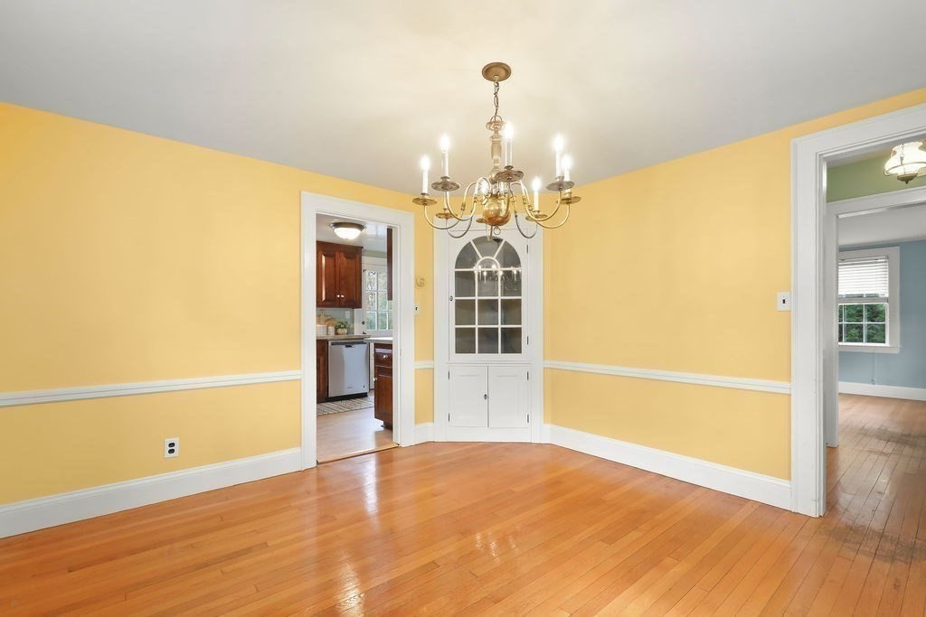 1297 Old Worcester Road Framingham, MA 01701 - Photo 11 of 41 a view of a big room with wooden floor and chandelier