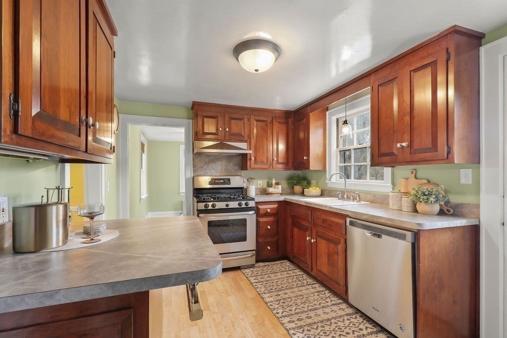 1297 Old Worcester Road Framingham, MA 01701 - Photo 14 of 41 a kitchen with a sink stove and cabinets