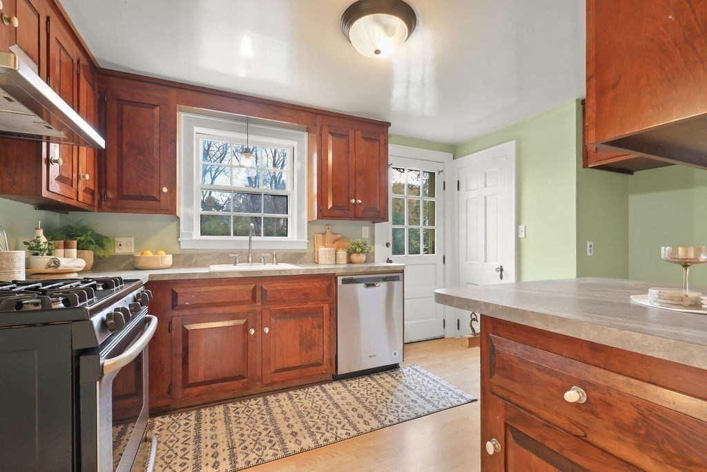 1297 Old Worcester Road Framingham, MA 01701 - Photo 15 of 41 a kitchen with stainless steel appliances granite countertop a stove a sink and a refrigerator