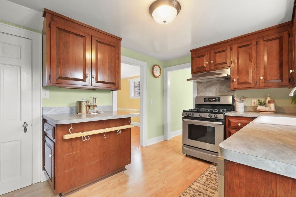 1297 Old Worcester Road Framingham, MA 01701 - Photo 16 of 41 a kitchen with stainless steel appliances granite countertop a stove a sink and a refrigerator