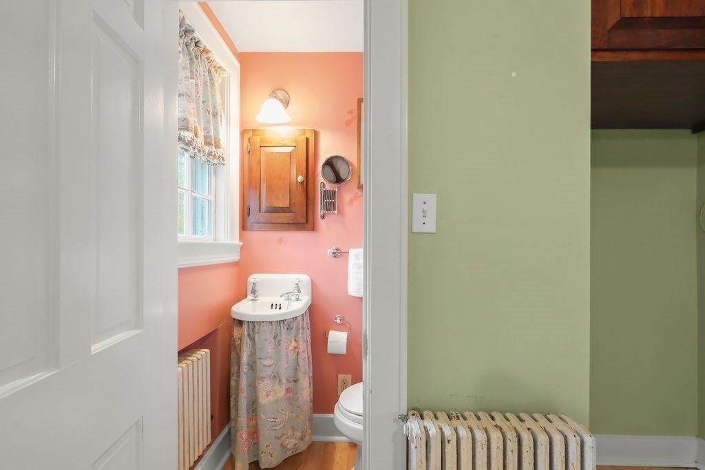 1297 Old Worcester Road Framingham, MA 01701 - Photo 18 of 41 a bathroom with a sink mirror and vanity